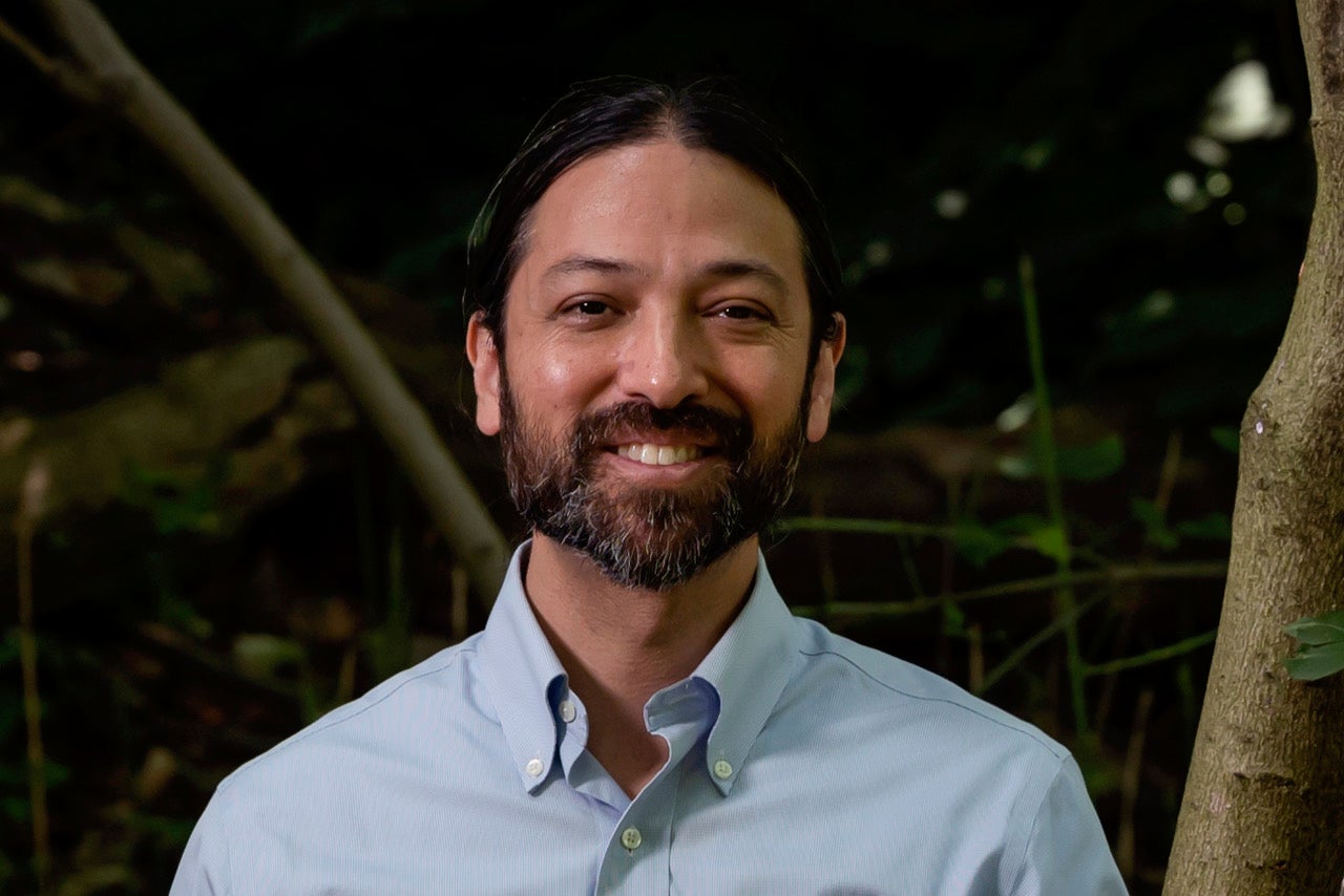 Sophia Choukas-Bradley posing in front of colorful artwork.
