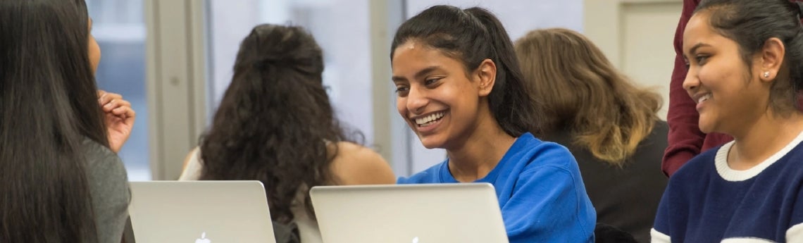 Students doing homework on laptops