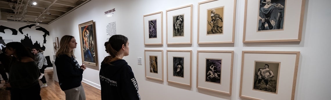 Students look at artwork in a gallery