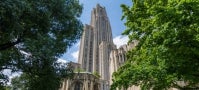 Cathedral of Learning through trees and foliage