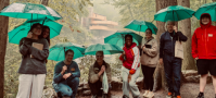 The Summer Design Studio class with Professors Drew Armstrong and Gabe Nolle on the Fallingwater Loop Trail with Fallingwater in the background