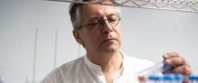 Graham Hatfull looking at a test tube in a laboratory