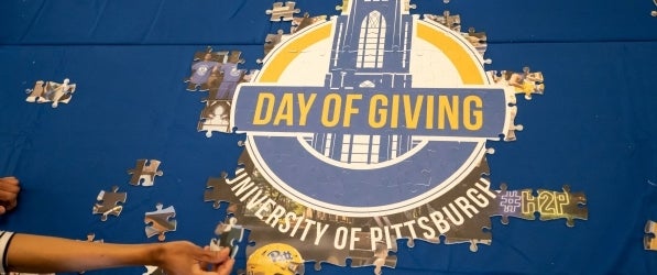 Image of a partially complete puzzle that says Day Of Giving University of Pittsburgh