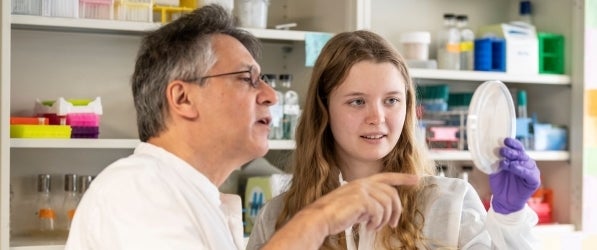 Male faculty member working in lab with female undergraduate student