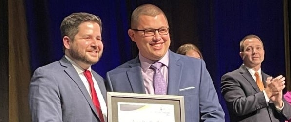 Ryan Hardesty, right, accepts his award from acting secretary of education. Ryan Hardesty, right, accepts his award