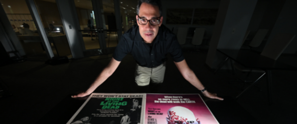 Adam Lowenstein with posters from George Romero movies