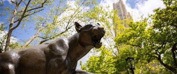 Panther status with Cathedral of Learning in the background with green trees