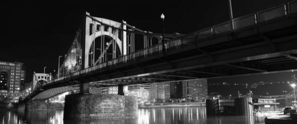 Pittsburgh bridge across the water at night